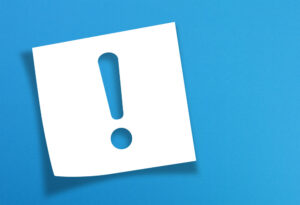 sticky note of an exclamation mark against blue background