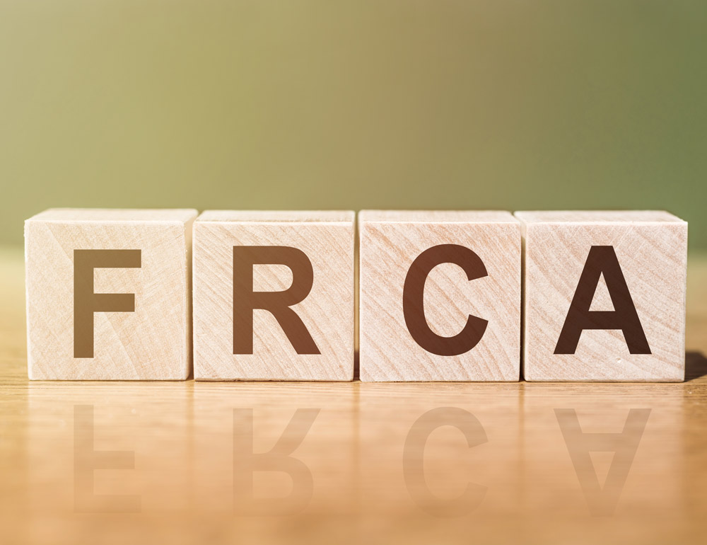 Wooden blocks spelling "FCRA." Compliance concept.